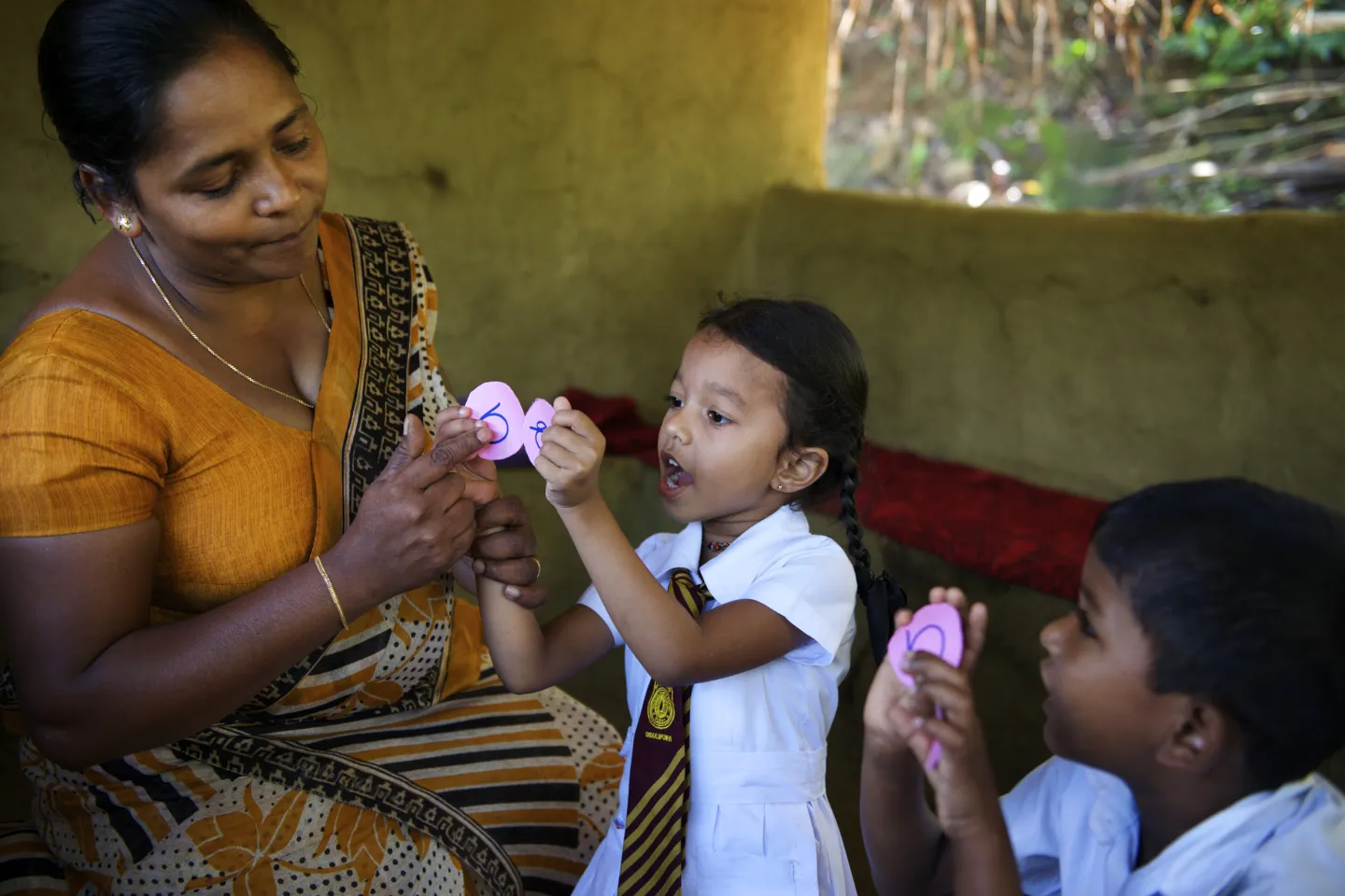 teacher helping a child learn letters