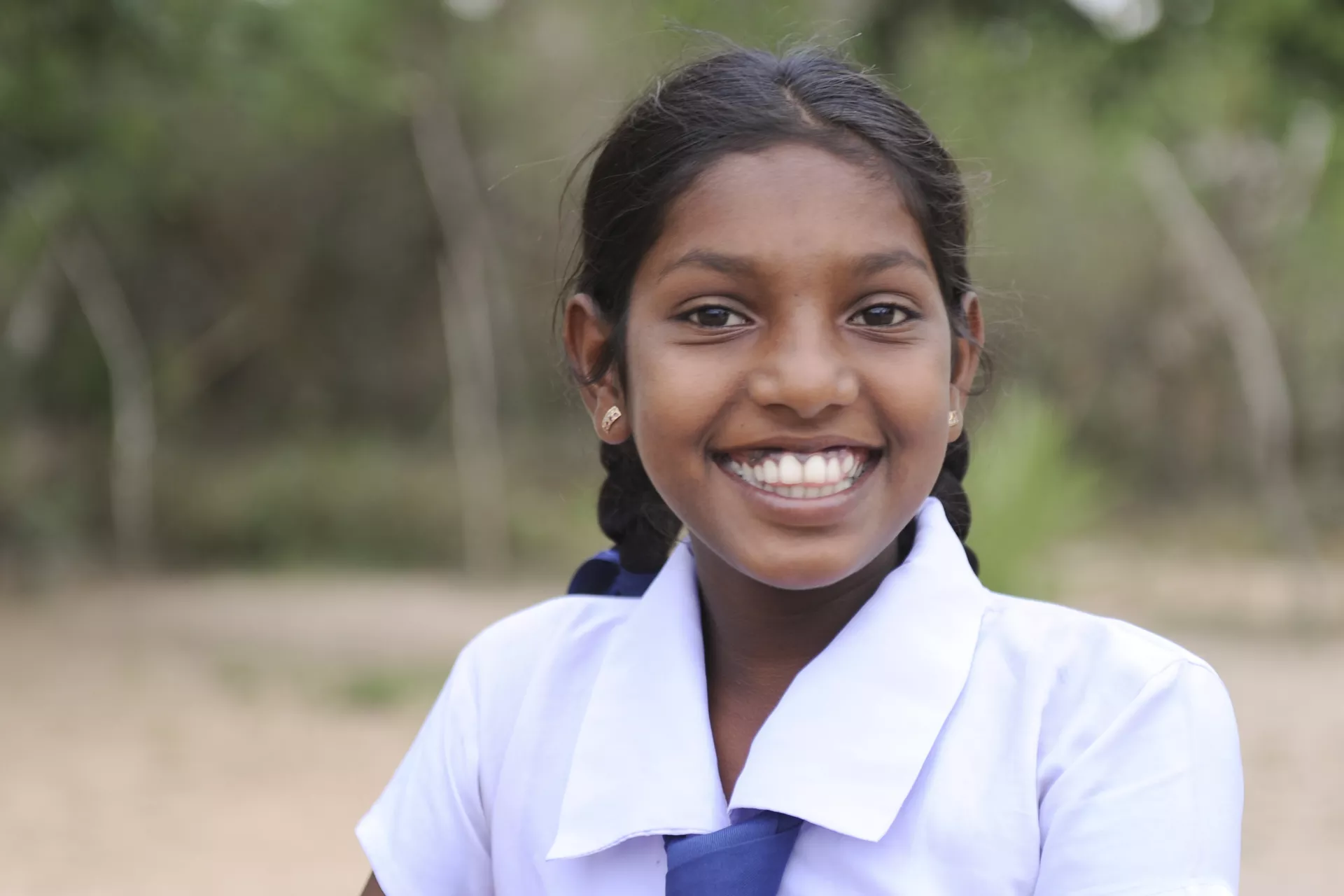 school girl in a rural village on her way to school