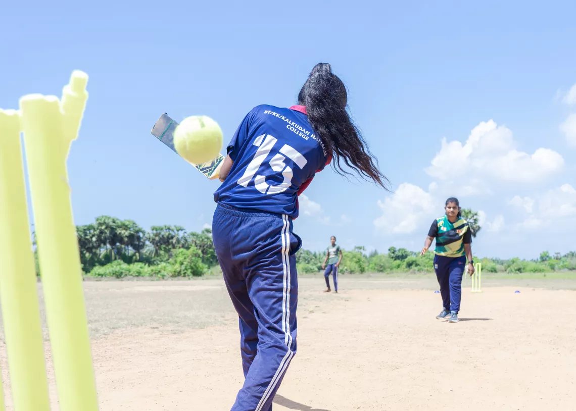 Yithurshika (left) practicing her batting skills