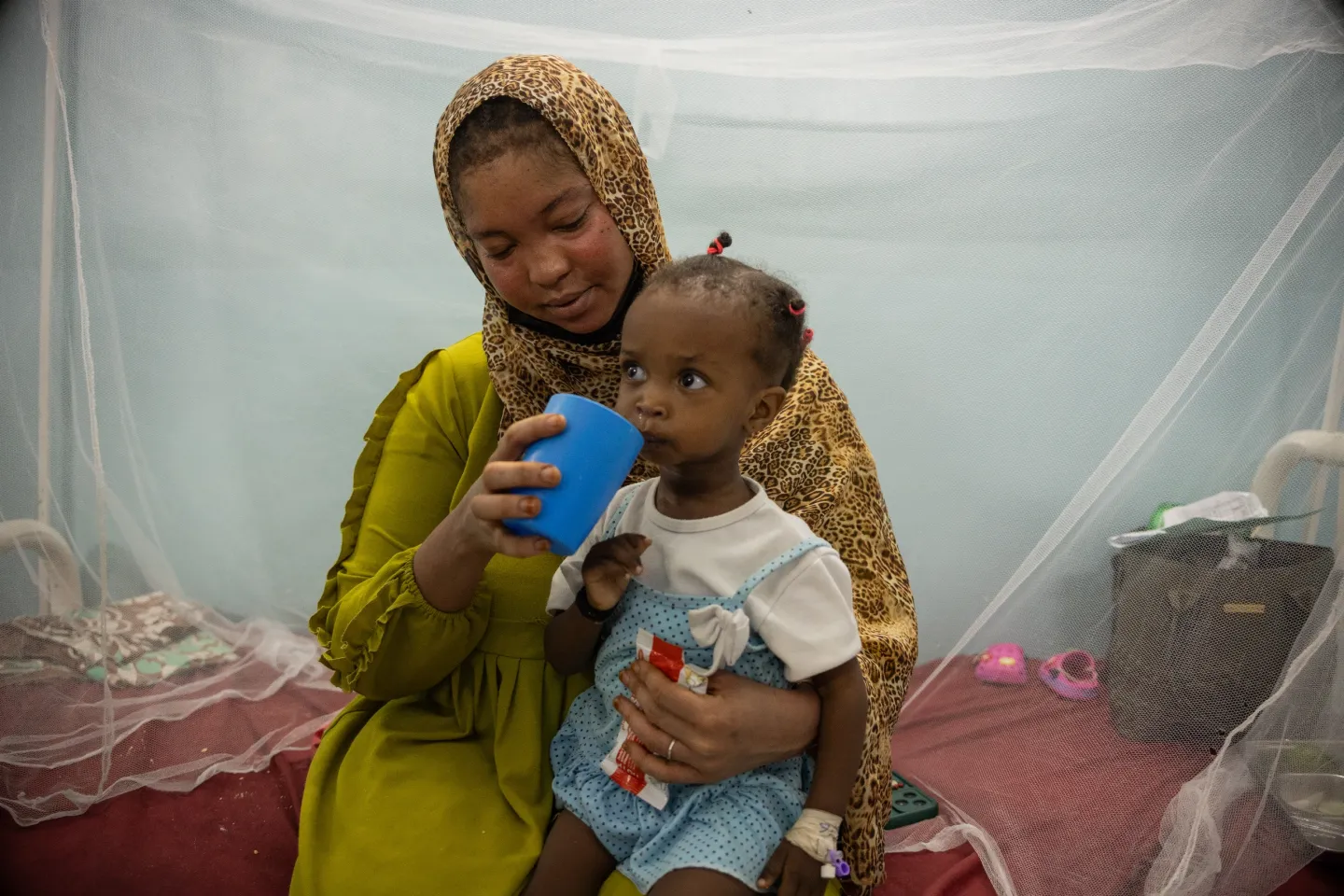 Wasila feeds her daughter Seleen, 18 months, who is suffering from severe acute malnutrition and admitted in the stabilization centre of Albuluk hospital in Khartoum State.