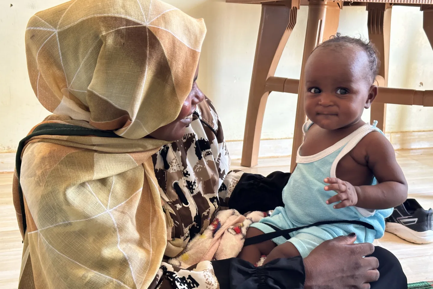 Iqbal enjoys a light moment with her 9-month-old son Layan after attending a session on infant feeding at the breastfeeding corner in Bir Hamad Primary Healthcare Centre
