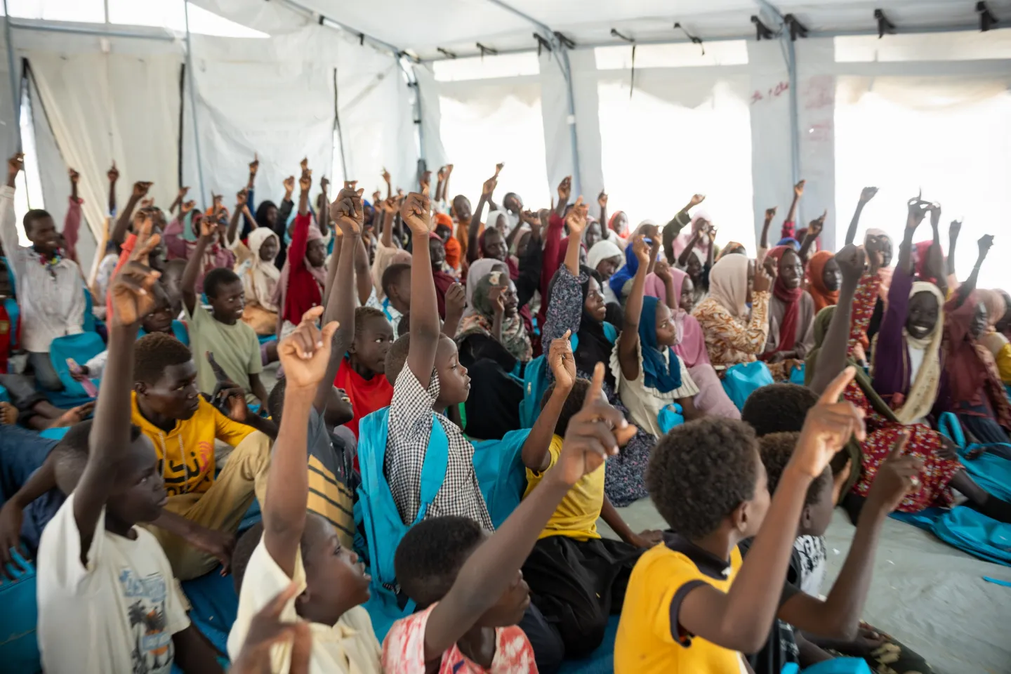 Boys and girls participate in a session at the UNICEF-supported ALP centre in Goz Al Salaam camp