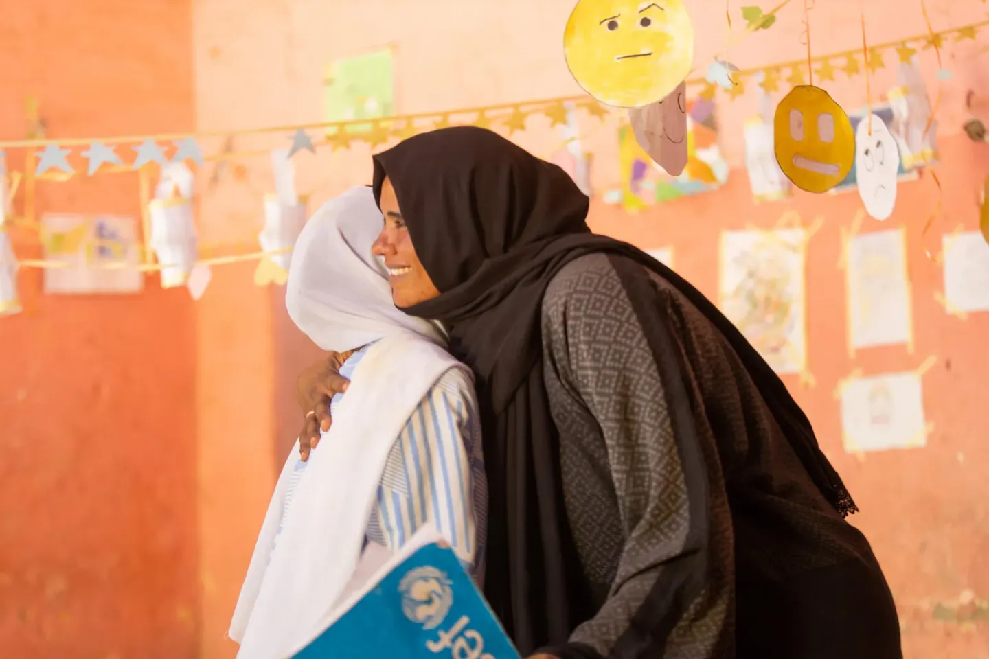 A social worker hugs a girl during a counselling session at a UNICEF child friendly space. 