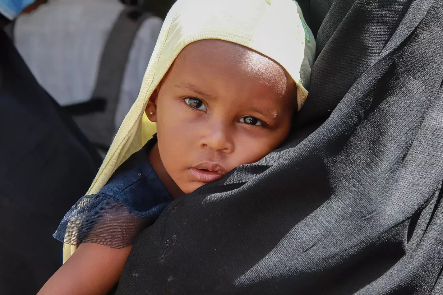 Sudan. A young child is held by her mother at a health facility in Atbara, River Nile state.