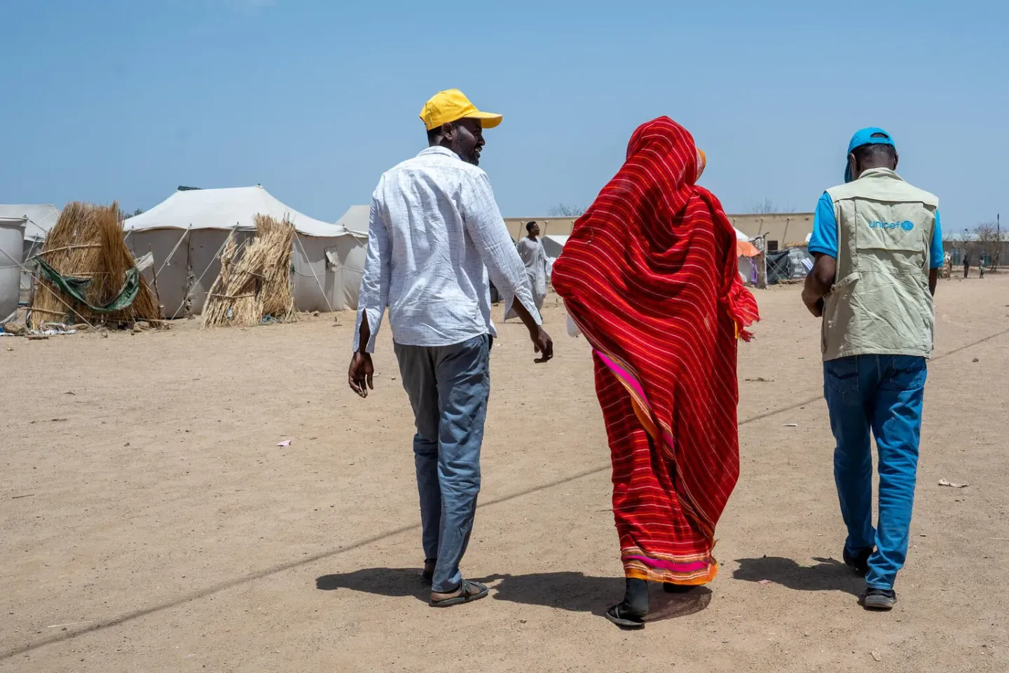 UNICEF staff and partners distribute mosquito nets in a camp