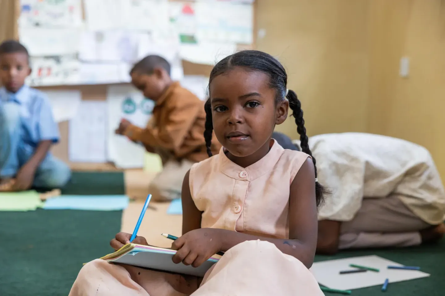 A child attends a drawing session at a child friendly space in Khartoum.