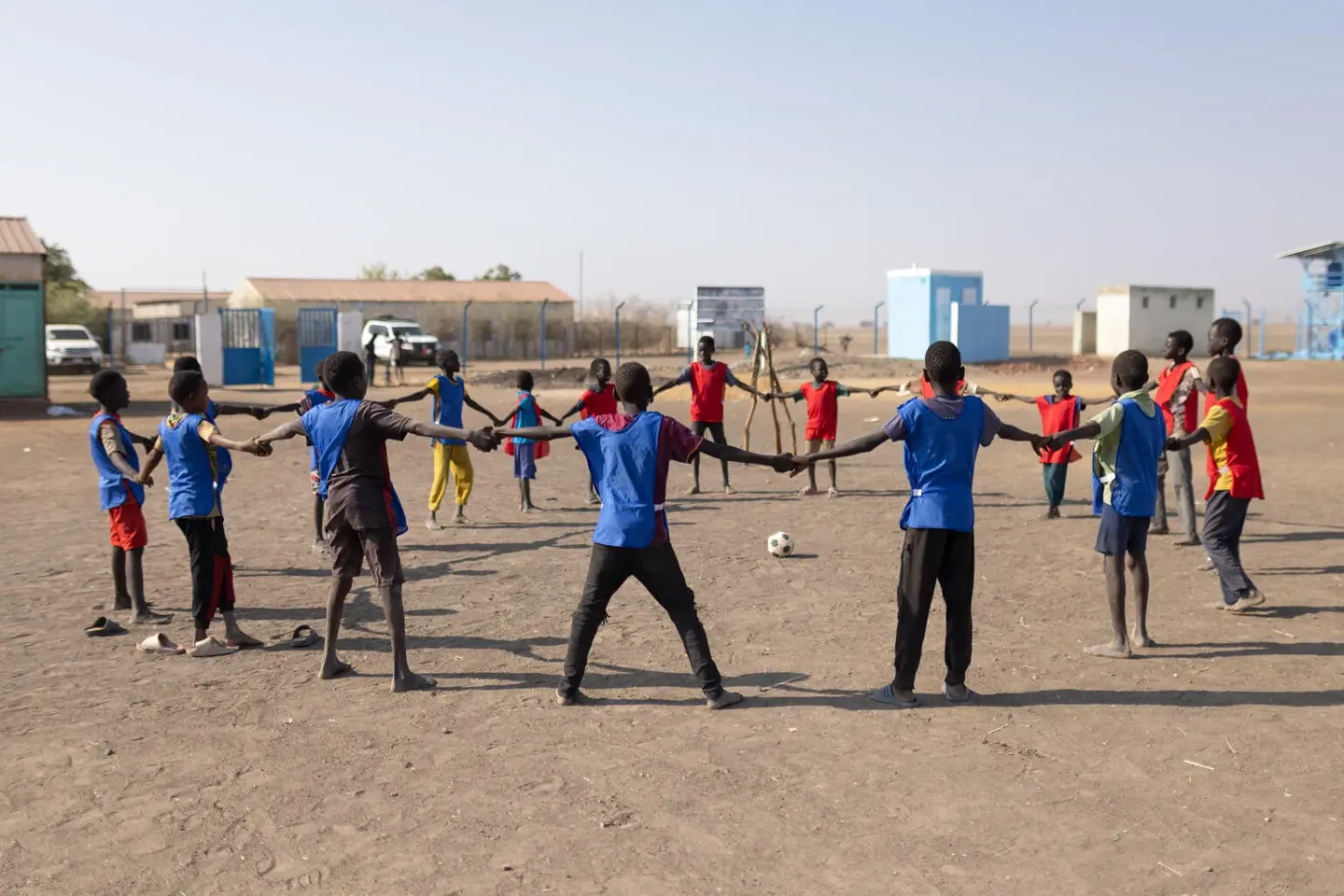 Children prepare to play a football match at a UNICEF-supported child friendly space (CFS)