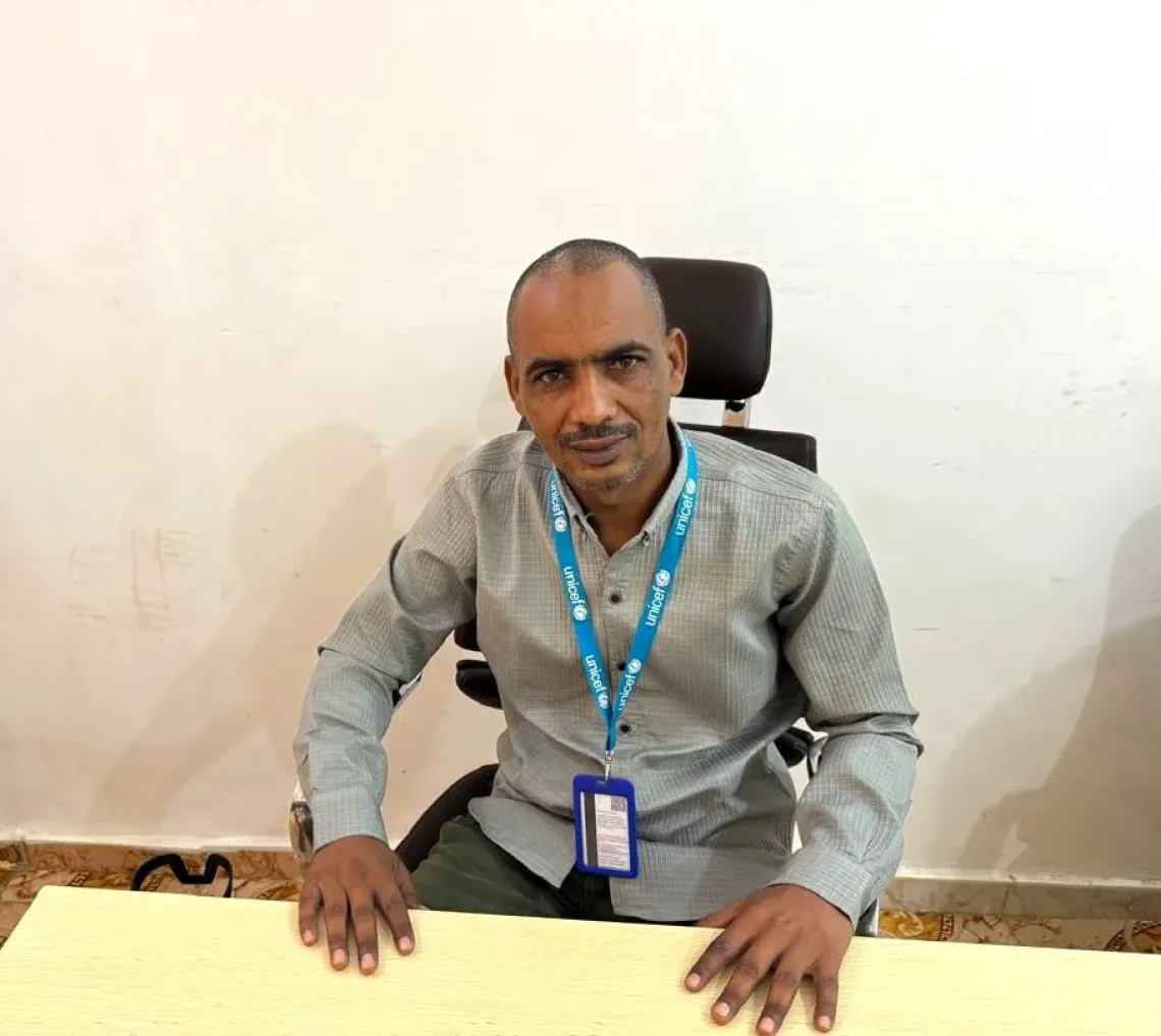 Eltayeb Hassan Security Officer, West Darfur sitting in an office.