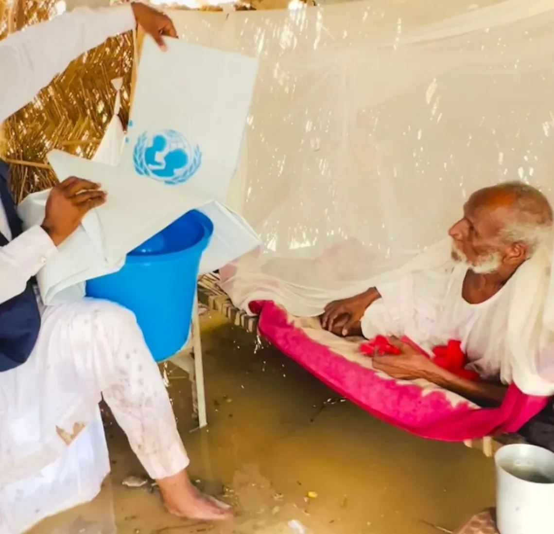 An elderly man trapped in a flooded home.