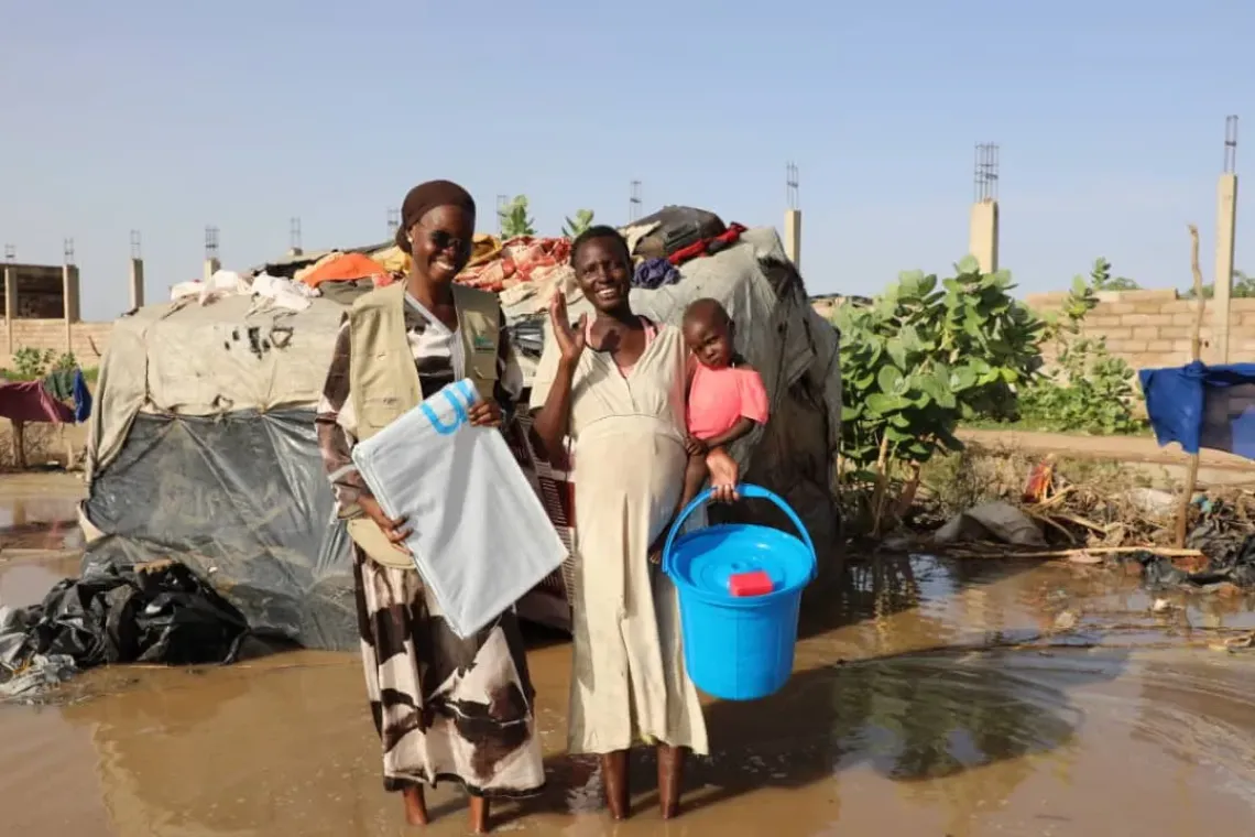 A pregnant mother receives support from UNICEF partners after flooding.