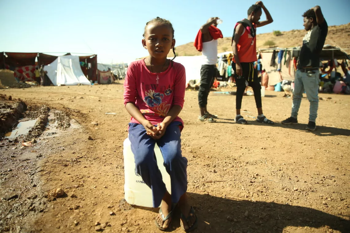 Tigray Refugee Crisis, Young Girl sitting on UNICEF Jerry Can
