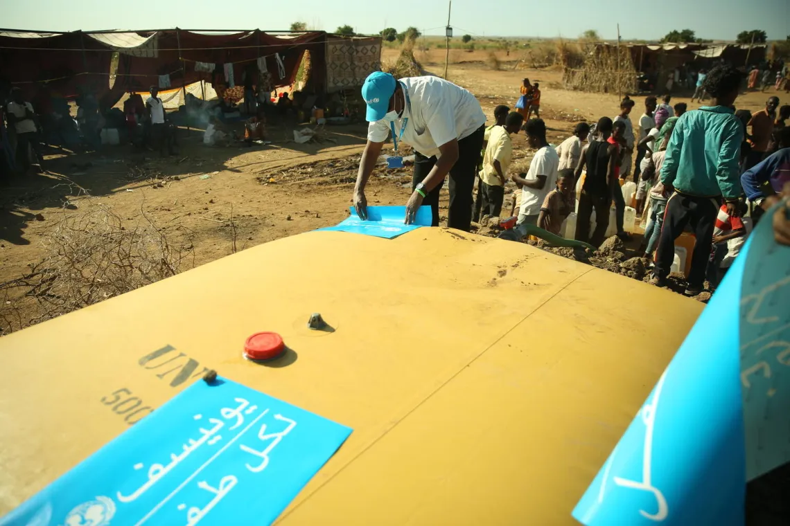 UNICEF Staff next to water bladder in East Sudan Border