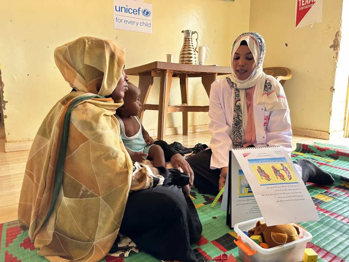 Rayan, a nutrition counsellor speaks to Iqbal after attending a session on infant feeding at the breastfeeding corner in Bir Hamad Primary Healthcare Centre