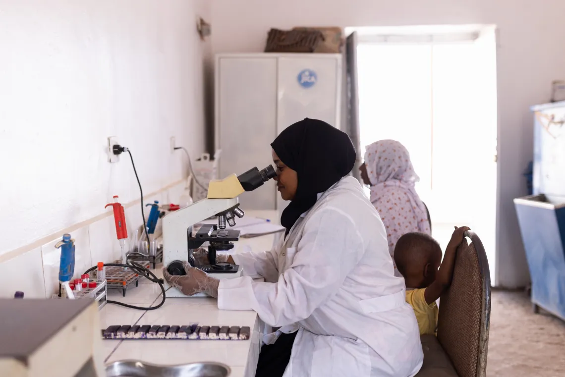 Amna, a laboratory scientist, performs tests at Alwehida Primary Healthcare Centre (PHC) in Sennar State.