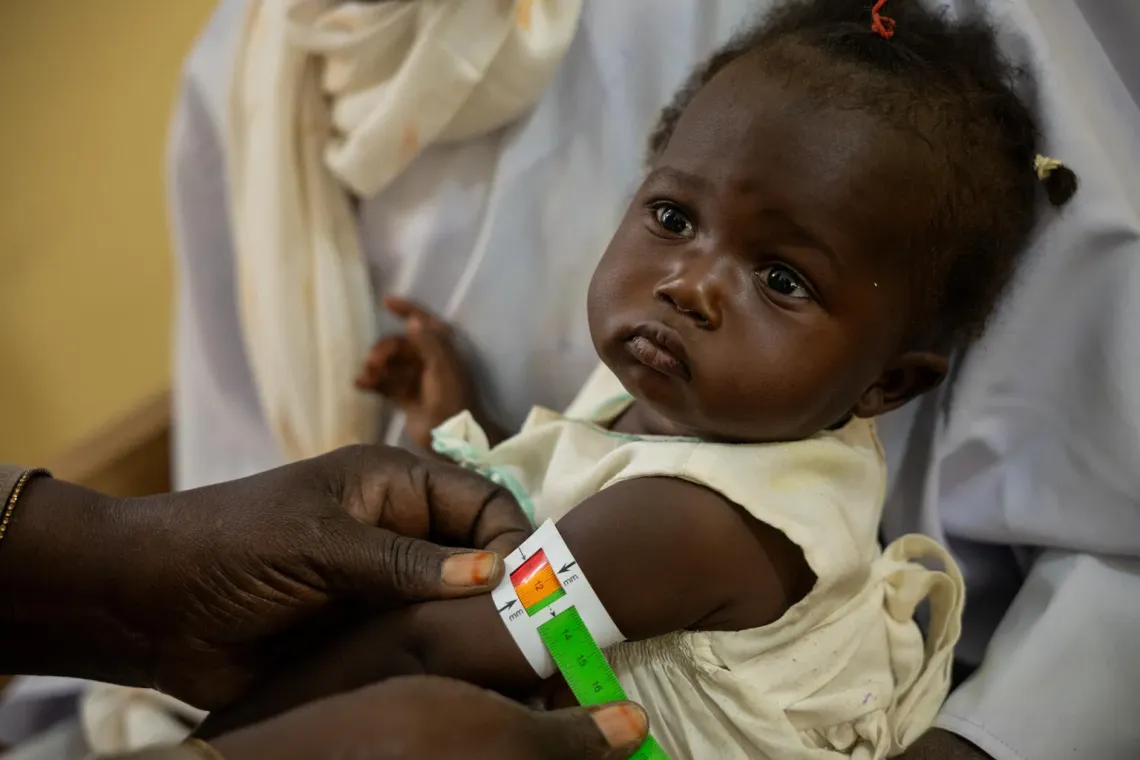 A child is screened for malnutrition at a UNICEF-supported health facility.