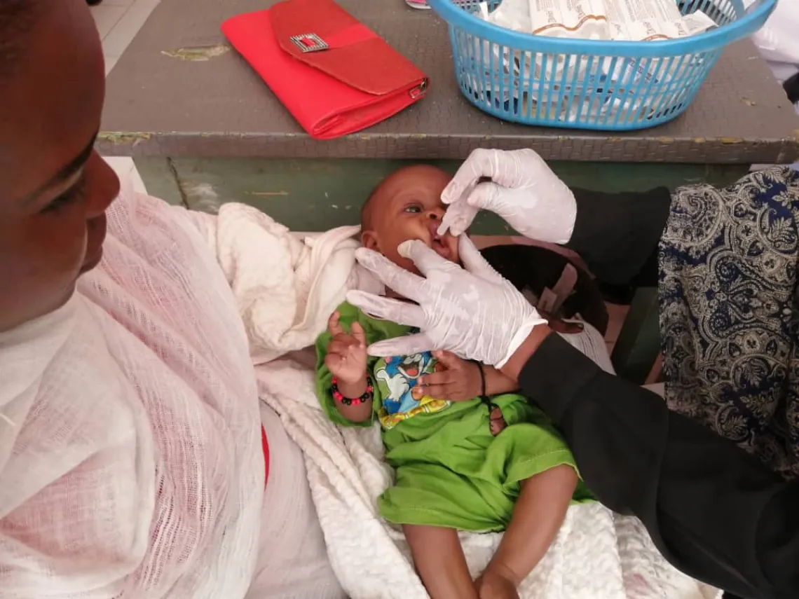 Baby receives oral vaccine