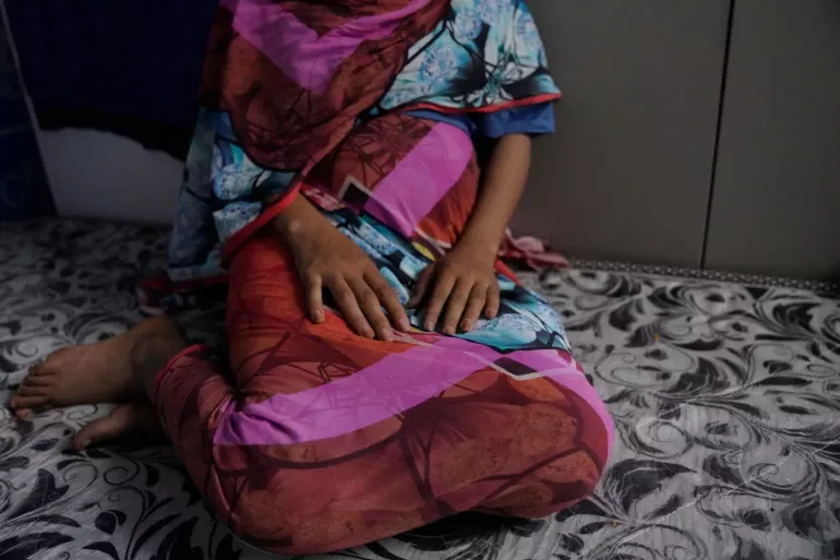 Sudan. A girl sits on the floor.