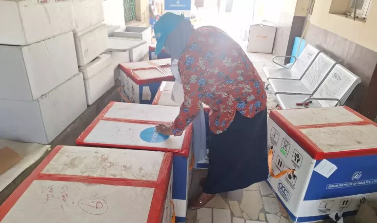 Sudan. A UNICEF staff member inspects boxes of vaccines.