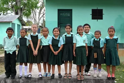 School children smiling for a photo. 