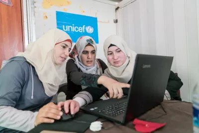 Girls using a computer at the Za&rsquo;atari Refugee Camp in Jordan