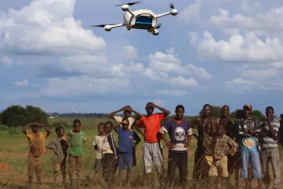 Children in Malawi watch a demonstration of Unmanned Aerial Vehicles (UAVs or drones) flying in Lilongwe, Malawi.