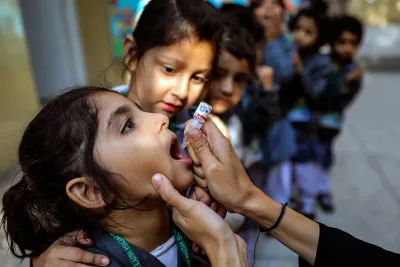 A child receives an oral vaccine. 