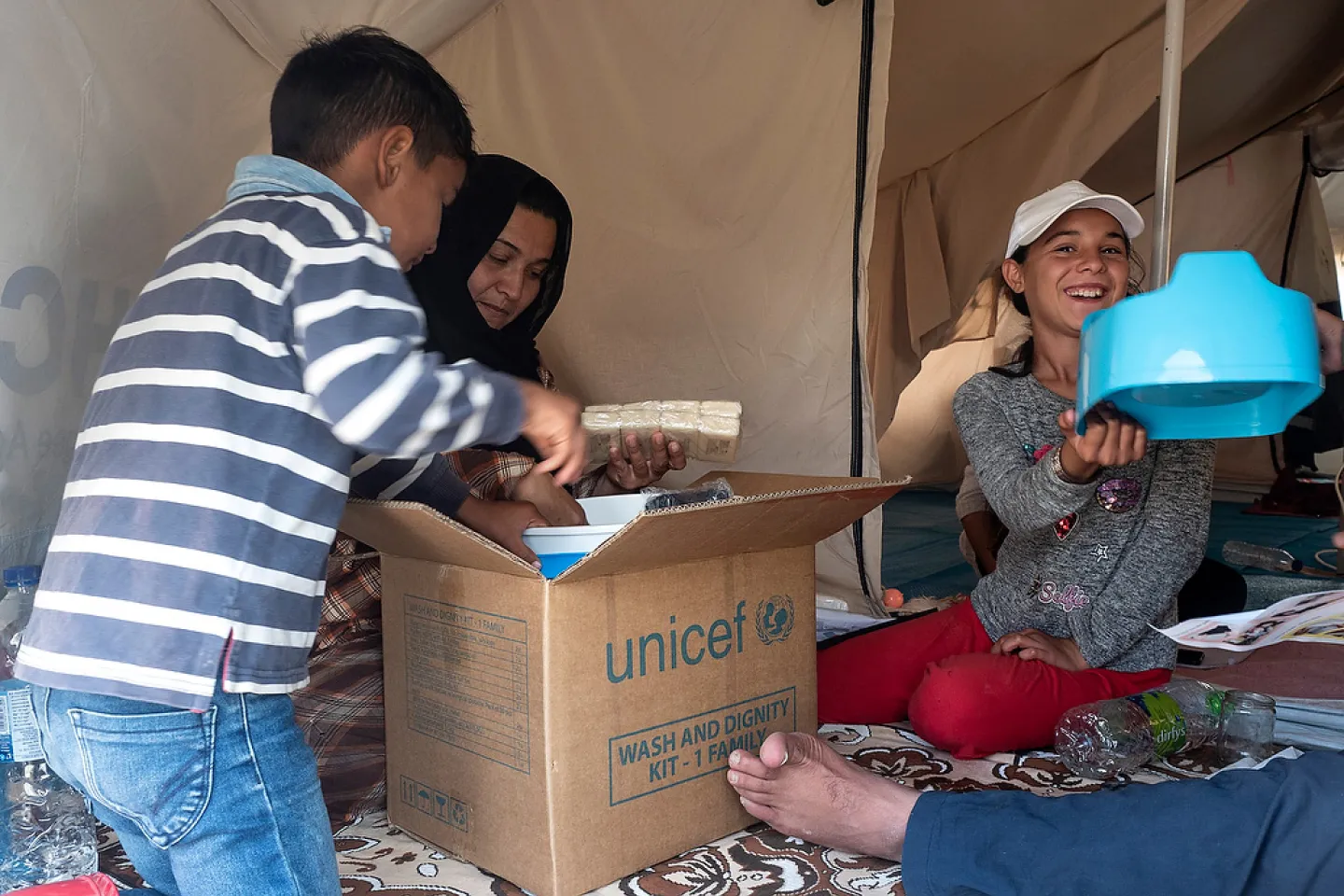 Kids unpacking a Wash and Dignity Kit