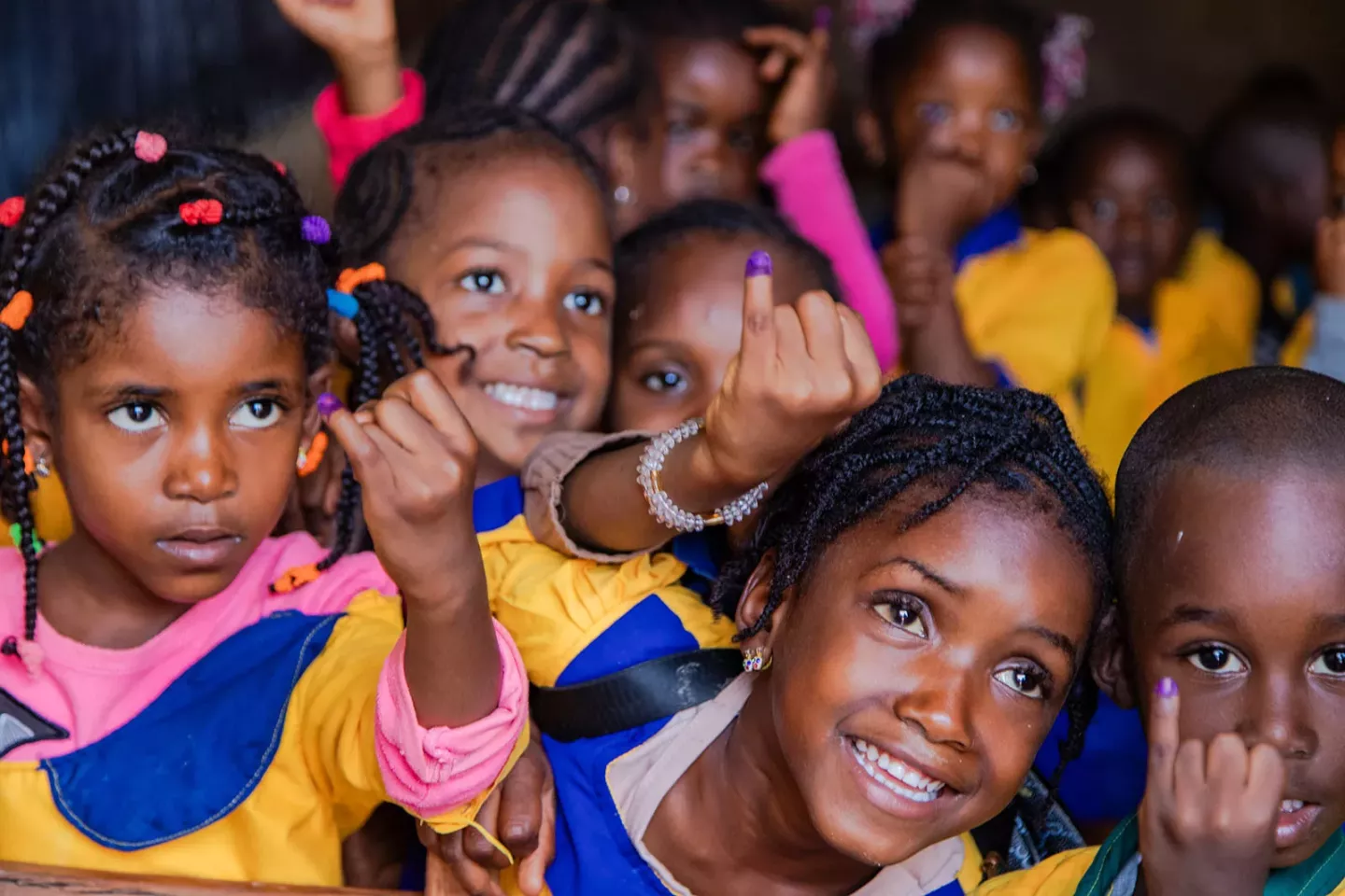 Children show their little fingers marked to signal that they received the polio vaccine. 