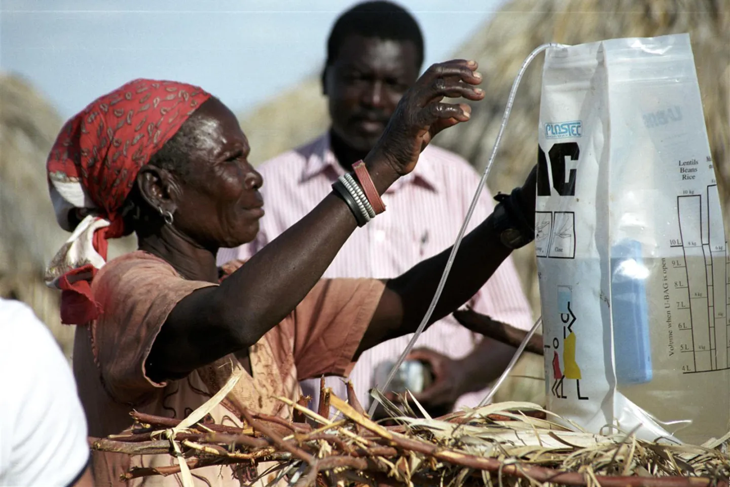 A woman shows her invaluable water filter supplied by Norwegian Government through UNICEF.