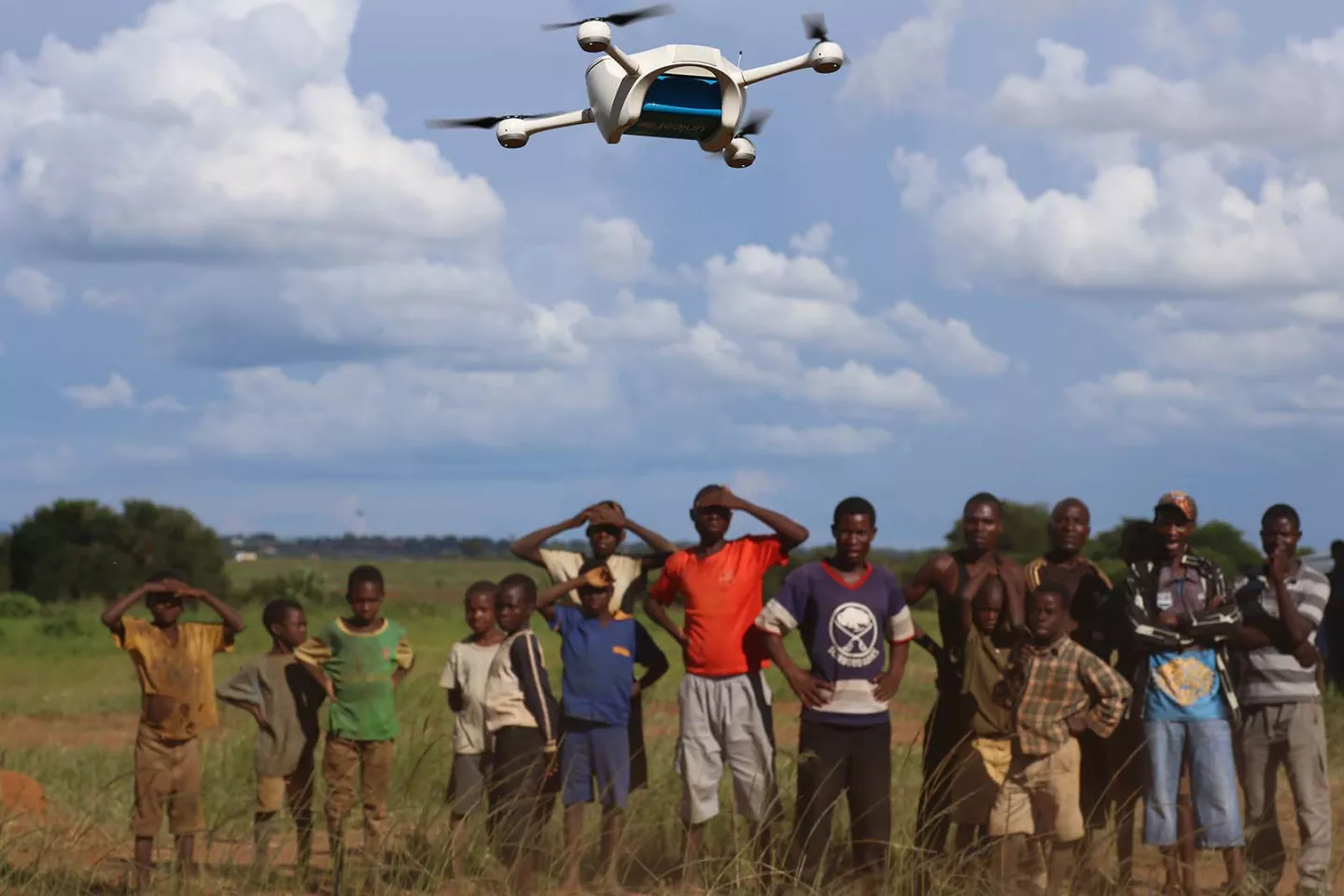 Children in Malawi watch a demonstration of Unmanned Aerial Vehicles (UAVs or drones) flying in Lilongwe, Malawi.