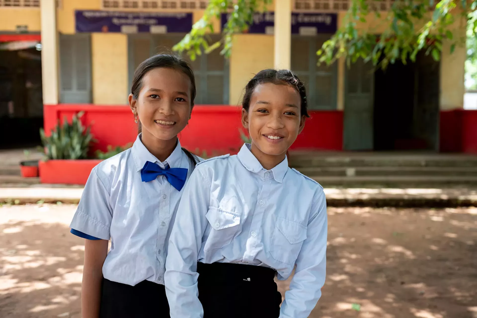Two female students smile for a photo. 