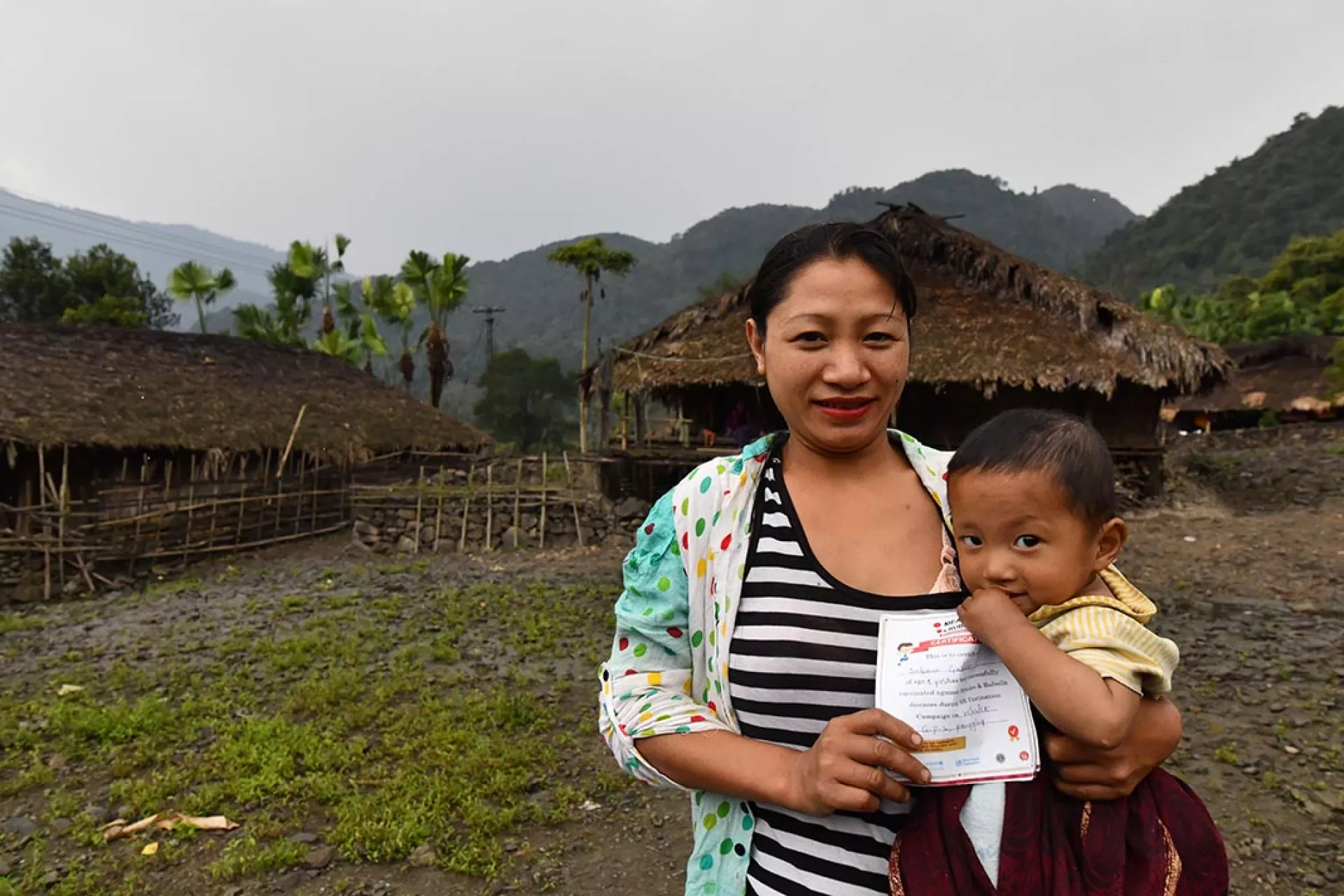 A mother with a child in her arms. 