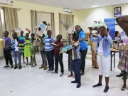 Children showing the results of a toy-making competition.