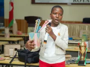 A schoolgirl with the toy she made her win the first prize.