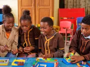 School children having fun while playing with LEGO bricks.
