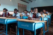 A group of young people sitting at desks in a classroom