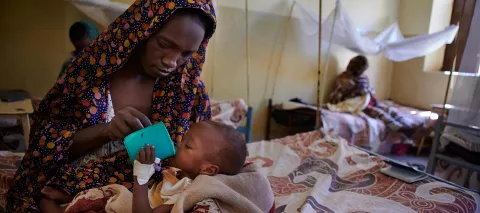 A 36-year-old mother, gives F70, especially prepared F70 therapeutic mil to her 7-month-old daughter, in the Therapeutic Feeding Centre for Malnourished Children in the city of El-Fasher, Sudan.