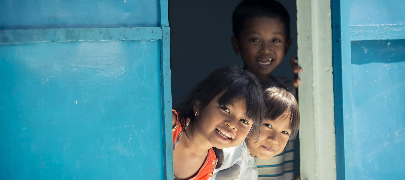 Children look from a window, Vietnam