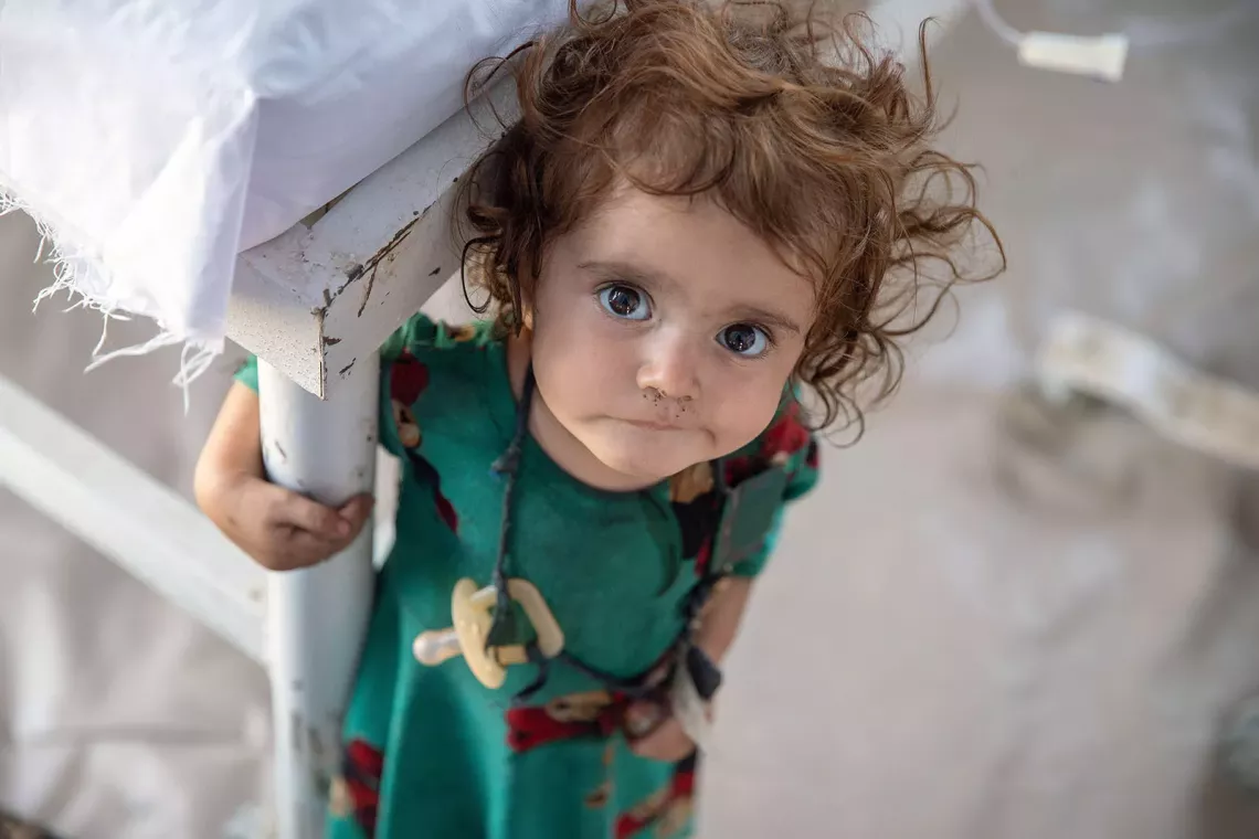 A young girl looks at the camera 