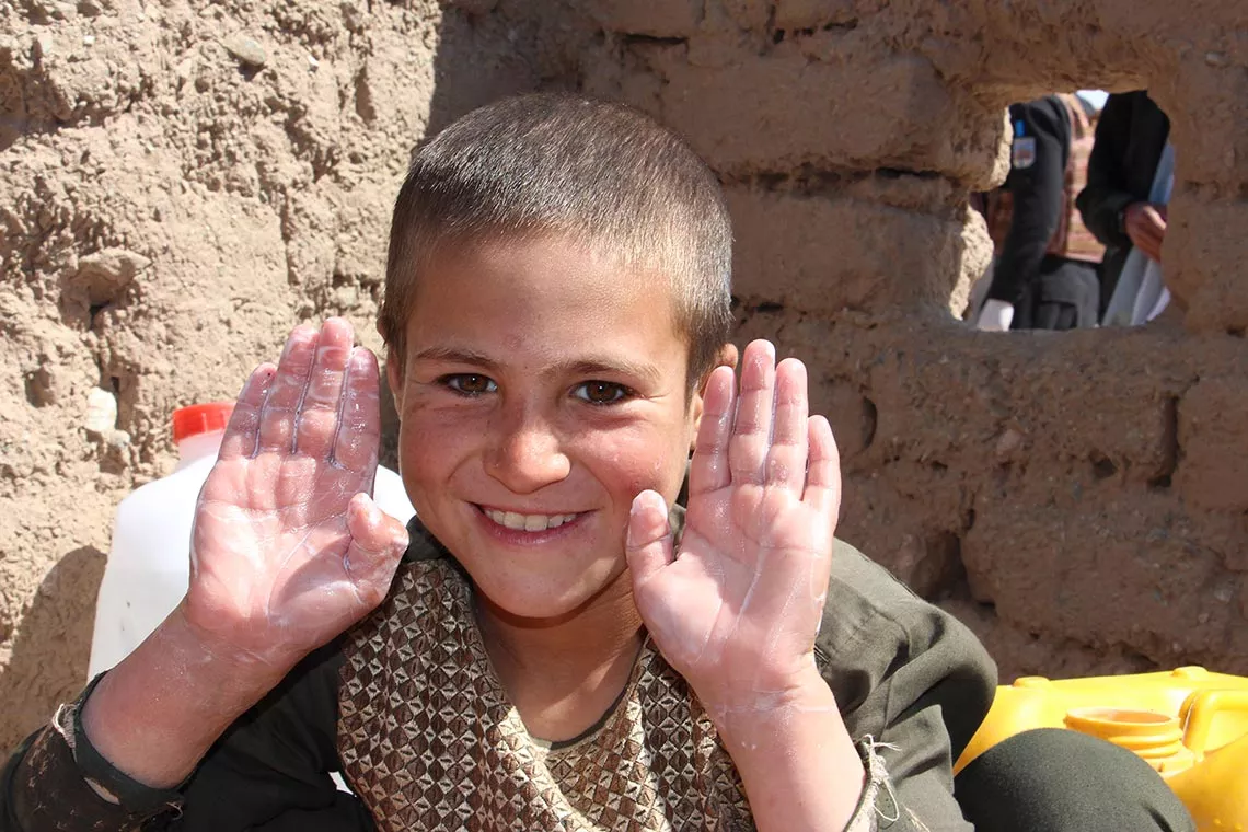 Ahmad Shah, 12, shows his clean hands after washing them with soap provided by UNICEF in Herat, Afghanistan. 