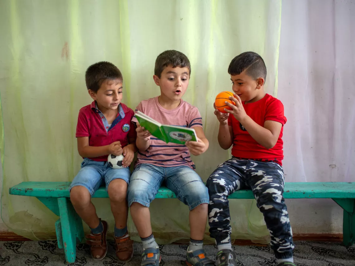 Boys playing at a kindergarten with UNICEF supplies