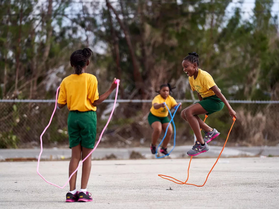 Children jumping ropes in a school garden