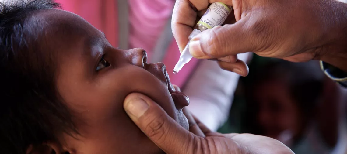 A Rohingya refugee child is administered an oral polio vaccine at an immunization centre in Bormapara makeshift settlement, Cox's Bazar district, Bangladesh, in December 2017.