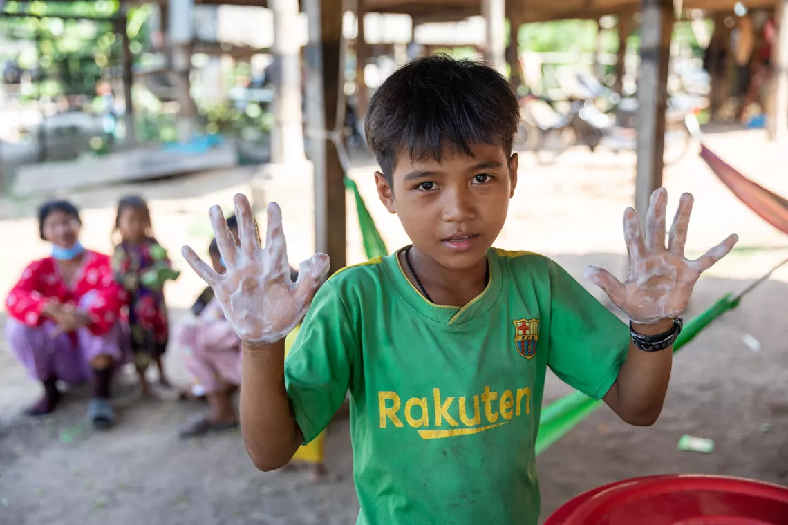 Panha Lak, eleven-year-old, washes his hands with soap acquired via UNICEF. 