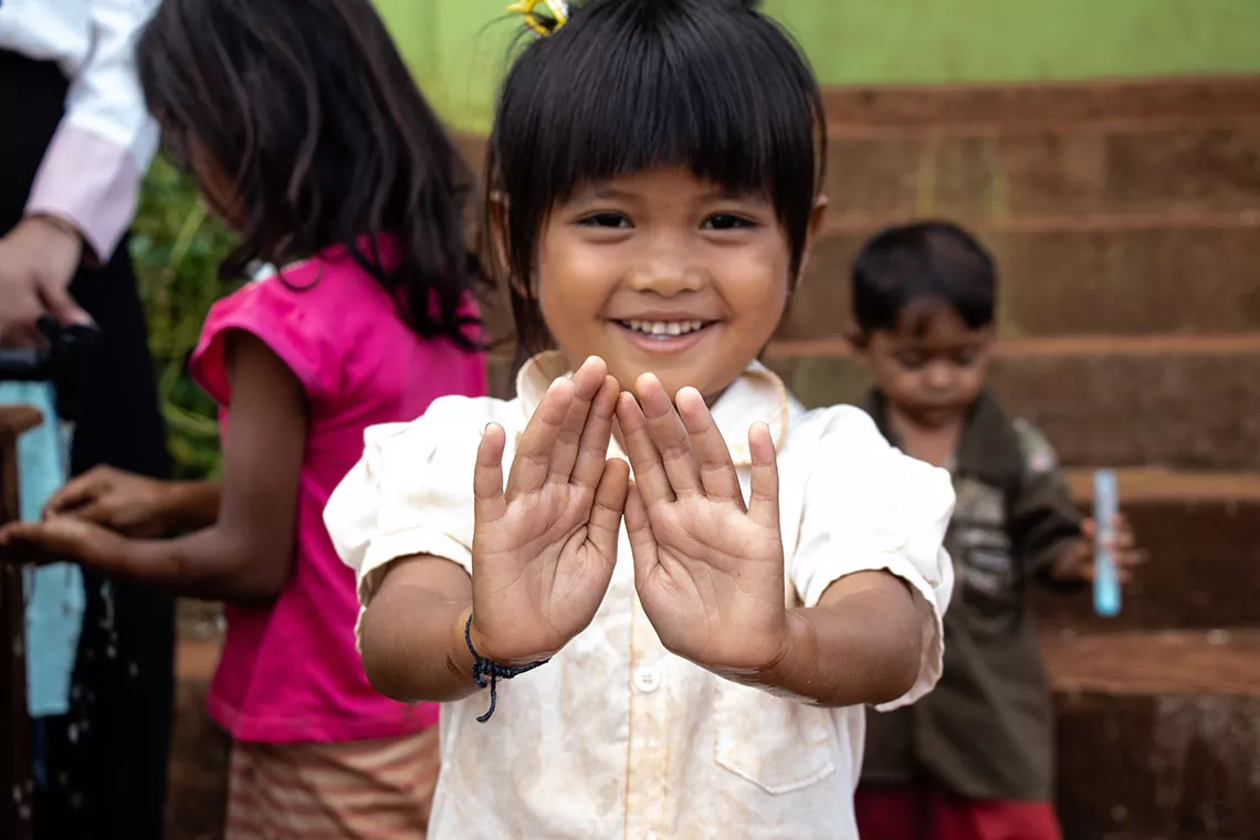 A girl in Cambodia&rsquo;s remote Ratanakiri district shows her clean hands, washed in a handwashing station which was procured and delivered by UNICEF Cambodia. 