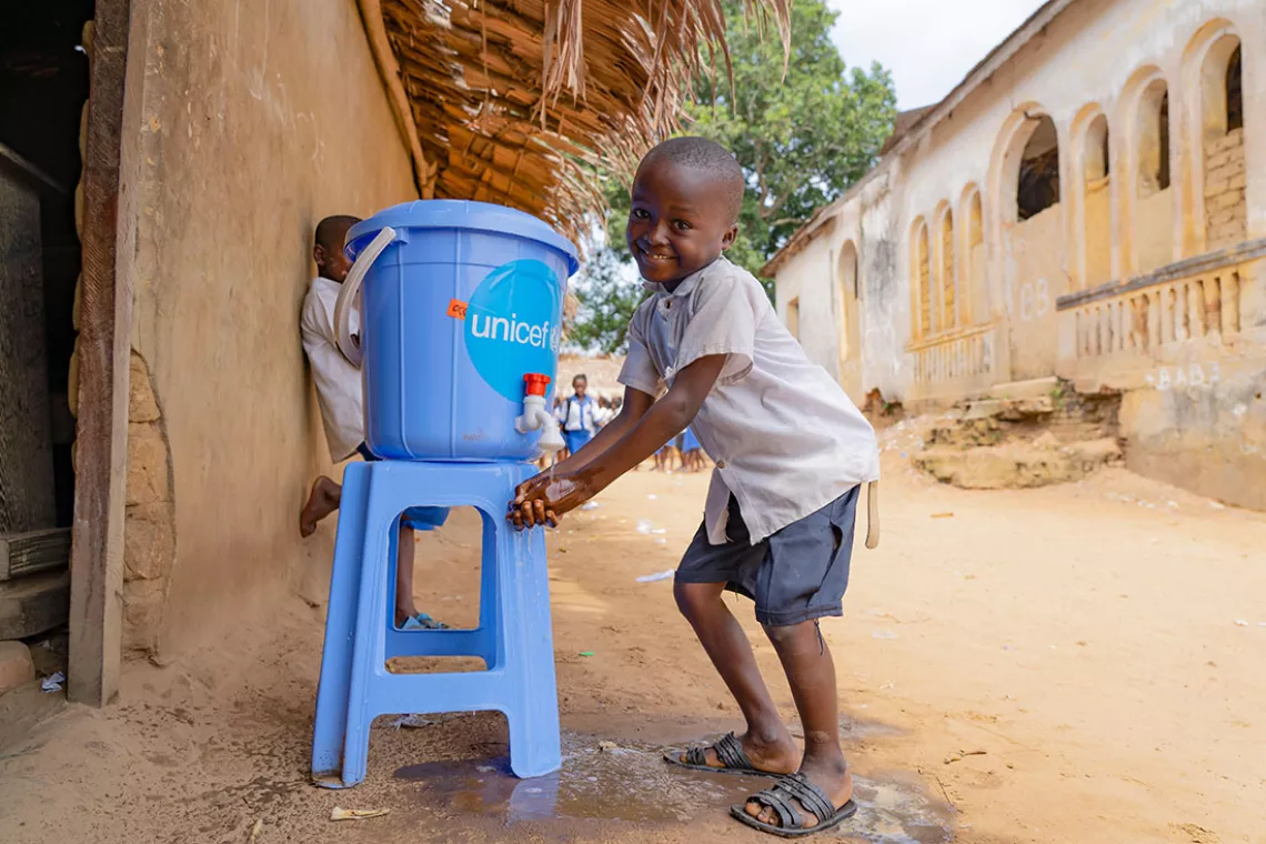 Bakonga, 8, washes his hands at Ilako Primary School in Mbandaka, DR Congo.