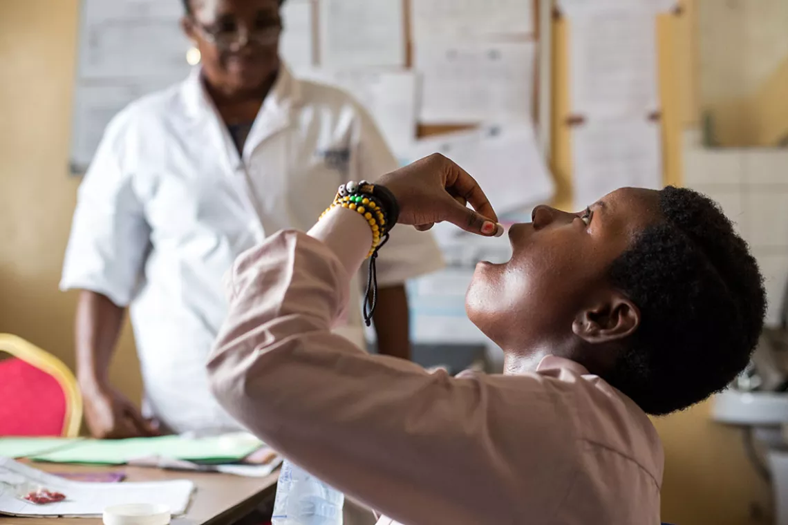 A pregnant woman takes anti-malarial medication at Mother and Child Health Center in Bumbu, Kinshasa, in the Democratic Republic of Congo.