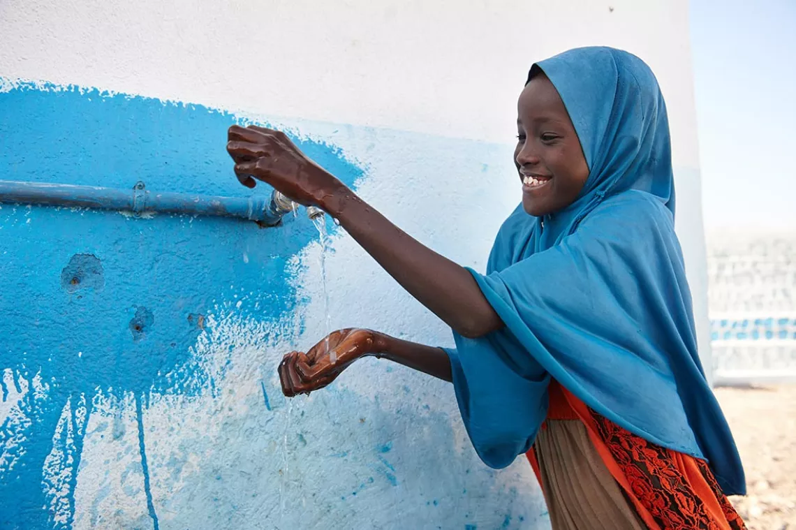 A girl child uses soap to wash her hands using tap water outside a UNICEF supported school in the village of Dafo, in the southern Djibouti, in February 2018.