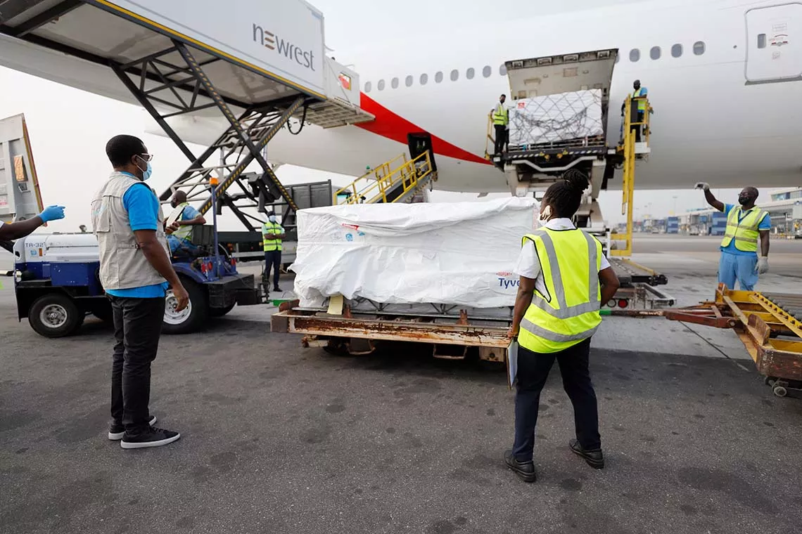 UNICEF staff unload the first international shipment of COVID-19 vaccines delivered by the COVAX Facility at the Kotoka International Airport in Ghana on 24 February 2021.