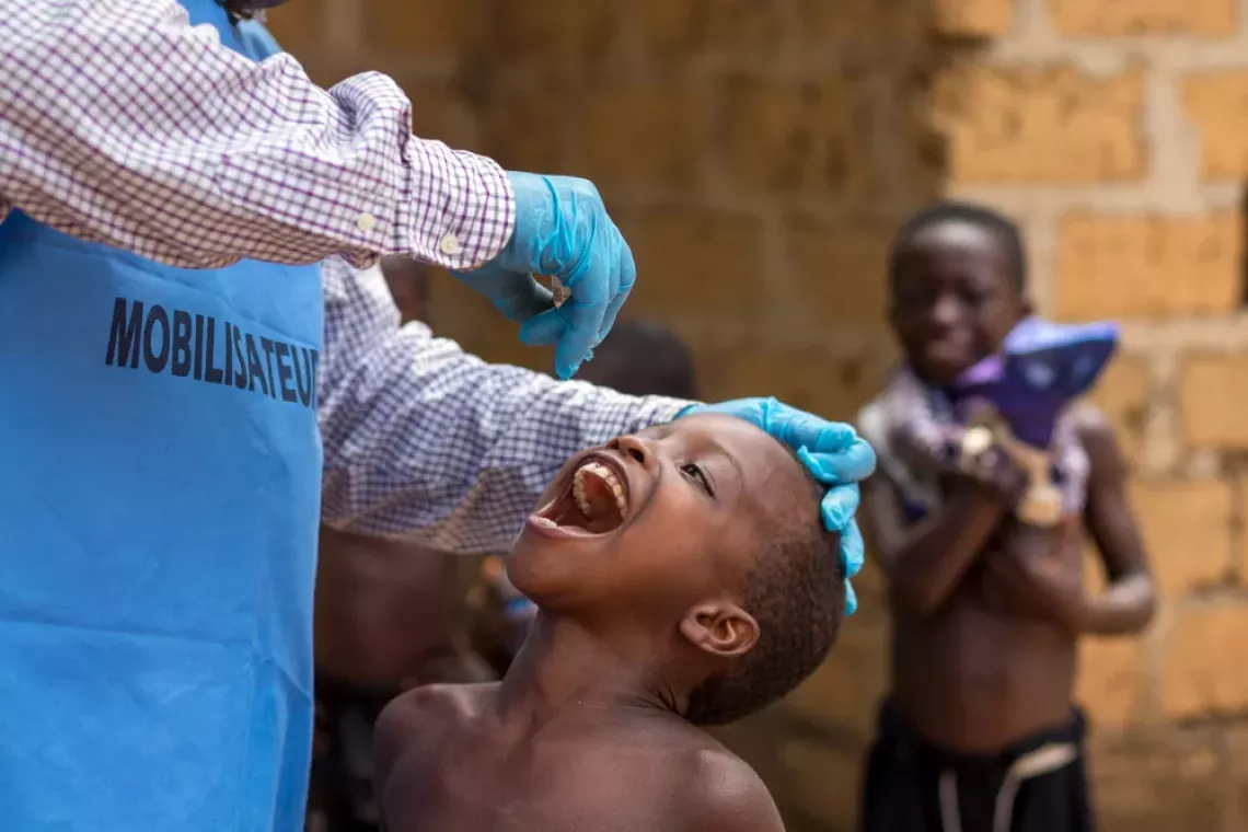A child receives the oral polio vaccine drops. 